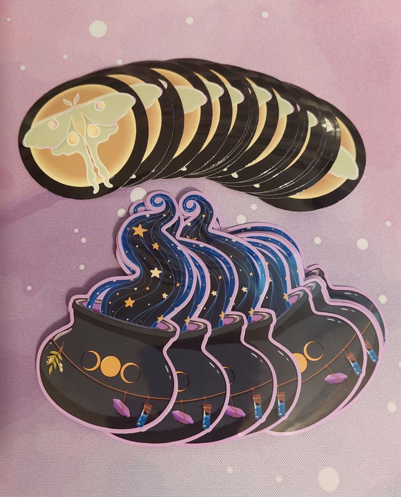A picture of a lunar moth sticker. The moth is in front of the moon. A set of cauldron stickers with magic rising from it are below the lunar moth stickers.