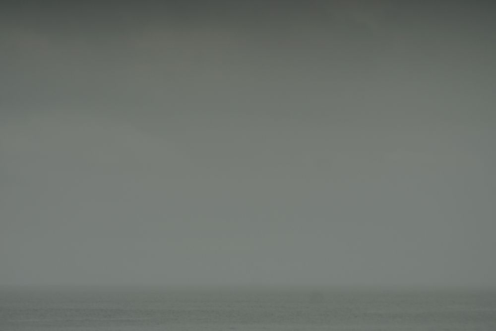 Grey. Small horizontal strip of slightly darker grey at the bottom of the picture might be sea. Who knows?