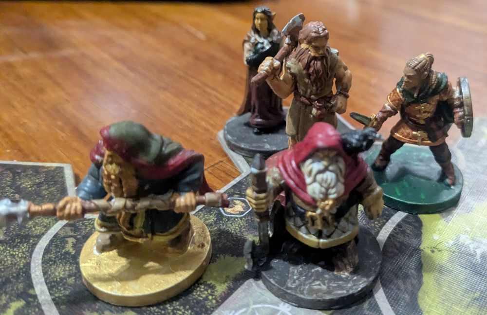 A map tile with five Journeys in Middle Earth painted minis. Dwalin and Balin are in the front row. Behind them are Arwen, Beorn, and Freahild of the Rohirrim. 