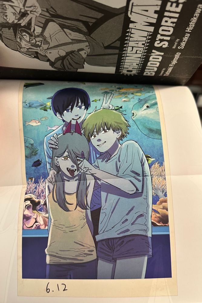 Fold out artwork of Denji, Aki, and Power as kids from Chainsaw Man Buddy Stories 