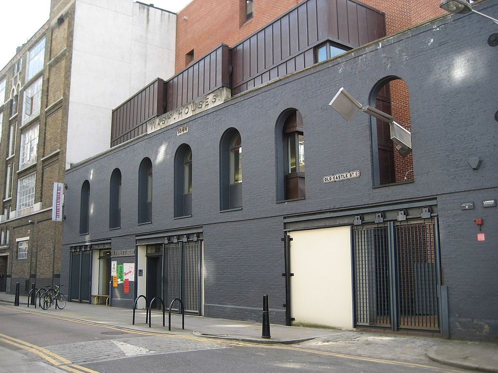 A photo of the outside of the converted wash houses on Old Castle Street, E1, with The Women's Library branding.