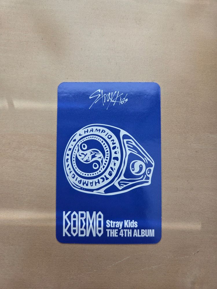 the back of a stray kids KARMA photocard. there's a championship ring (in the style of NFL Superbowl rings) drawn on it