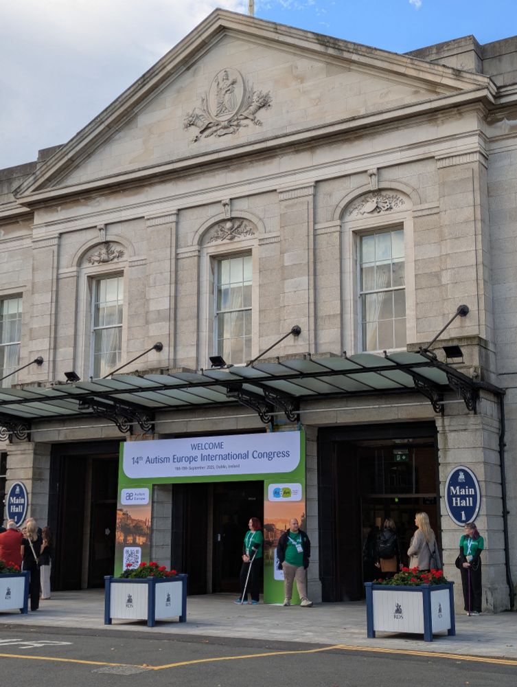 Photo of the front of the Royal Dublin Society with a banner for the Autism Europe conference. 