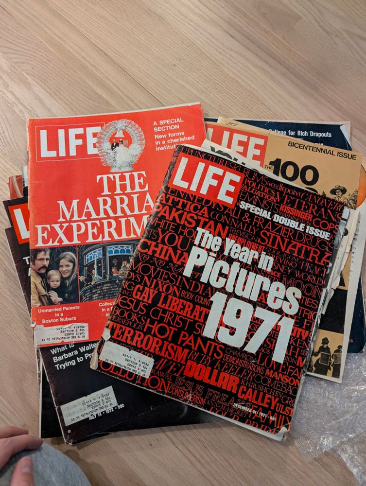 Several life magazines from the 70s. Headlines read "the year in pictures 1971" and "the marriage experiment"