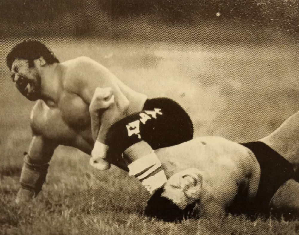 Saito's got Inoki locked up in an armbar of some sort.
