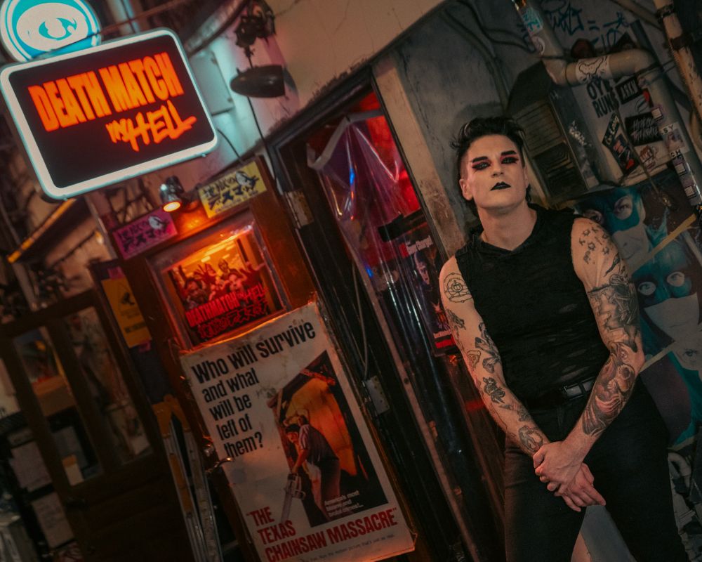 Ridiculously hot goth guy in front of horror themed bar in Golden Gai, Shinjuku called Death Match in Hell.