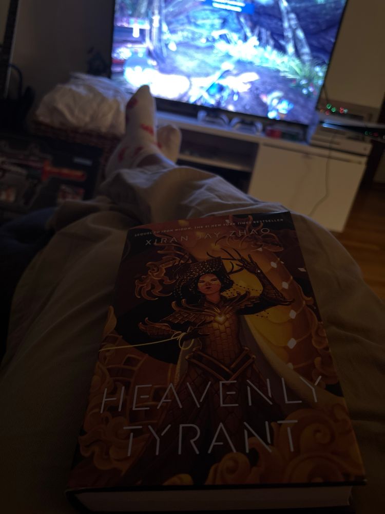 Eagerly awaited book Heavenly Tyrant and Monster Hunter World on the tv in the background 