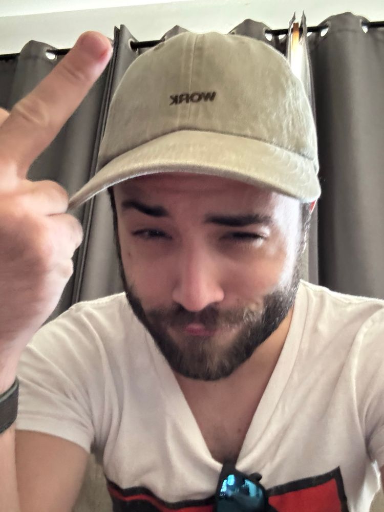 me taking a quick (blurry) selfie, flipping off the camera and making some sort of bear face