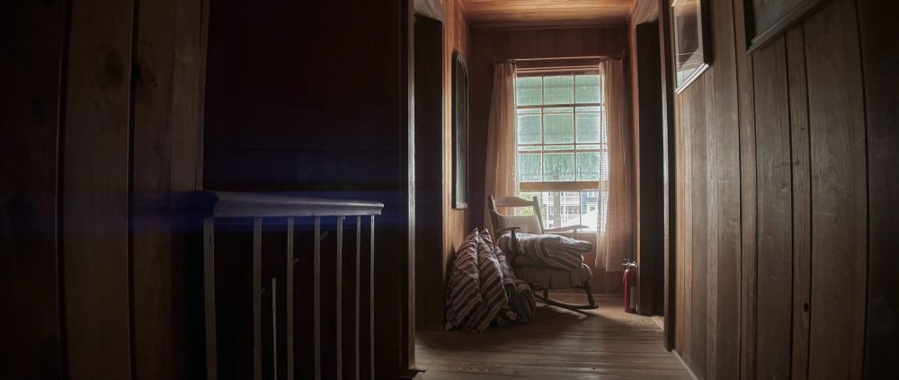 Anamorphic photo of a hallway in a vintage beach cottage