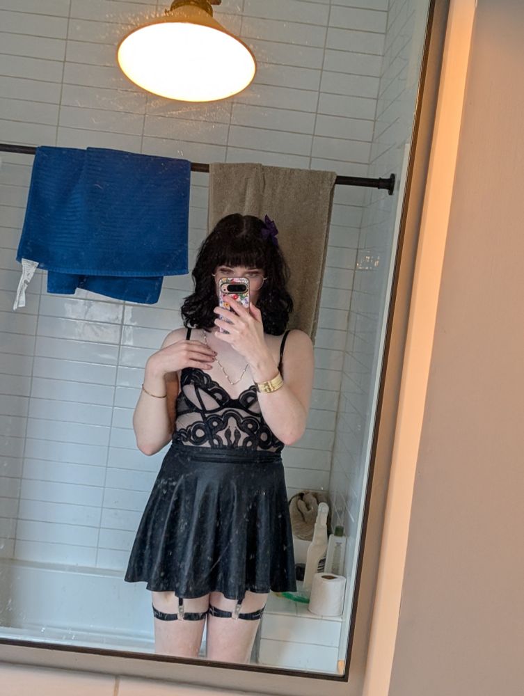 mirror selfie of me in a thistle and spire black bodysuit and black leather skirt