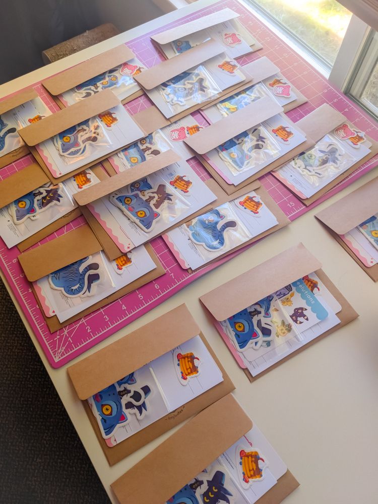 Photo of a table covered in envelopes and sticker orders
