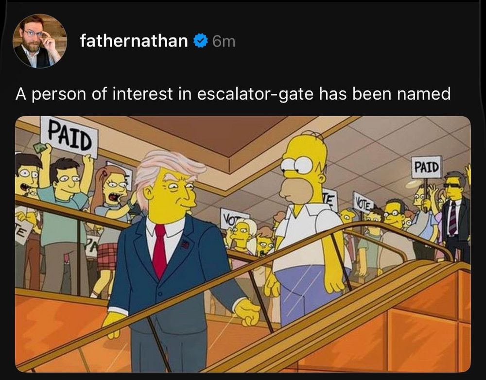 A Threads post from @fathernathan showing a screenshot of an old Simpsons episode with Homer Simpson riding the escalator behind Donald Trump:

A person of interest in escalator-gate has been named 