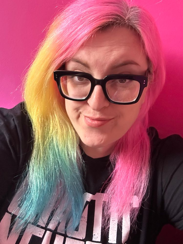 A selfie showing more muted rainbow hair colours (plus eight weeks of roots)