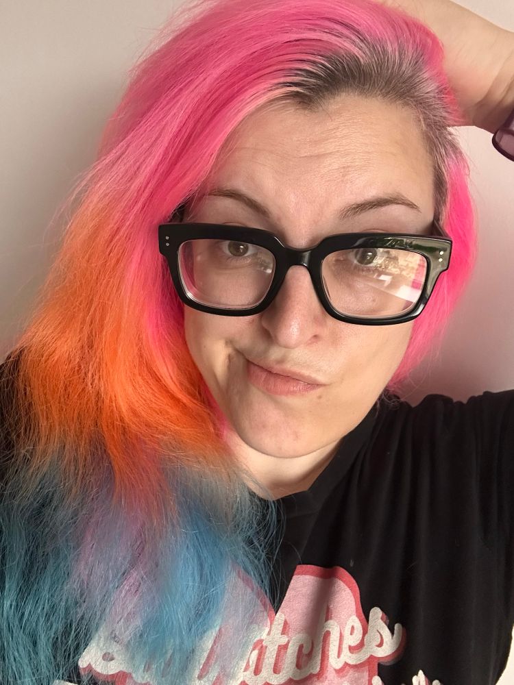 Faded and grown out pink, orange and blue hair. The blue has definitely suffered most.