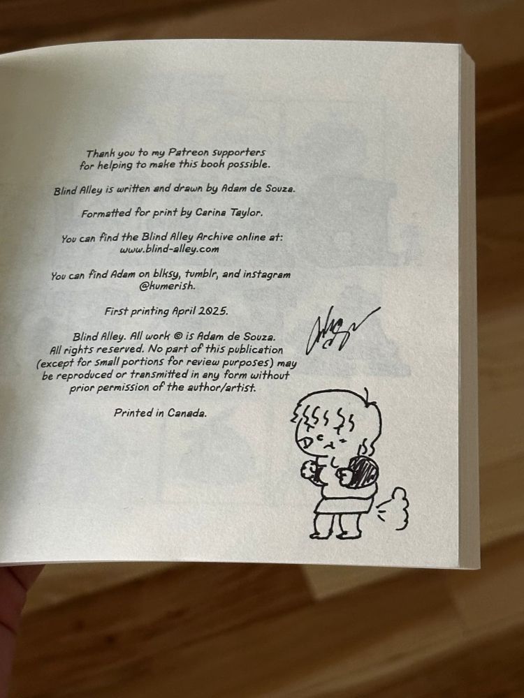 A photograph of the first page of the Blind Alley Year 3 comic book. Adam's signature is above a doodle of the character Oliver pushing out a fart with a determined pose.