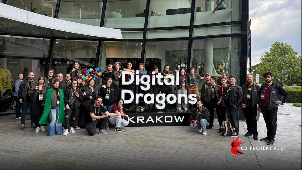 Over 30 CD Projekt Red employees pose around a sign that reads, “Digital Dragons Krakow”.