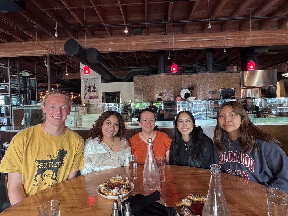 4 undergraduate students with Dr Delgado (professor) at a restaurant 