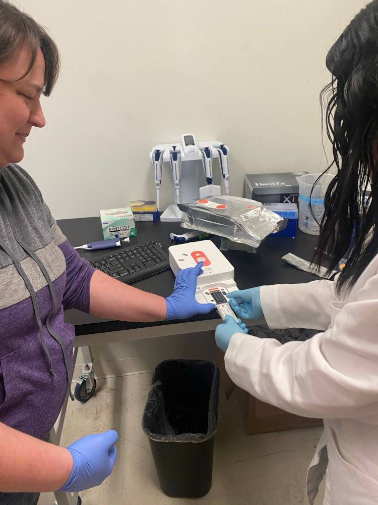 Scientist adding a sequencing flow cell