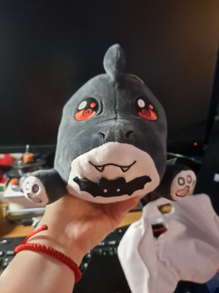 The Click's halloween Mango plushie without the white sheet viewed from the front.