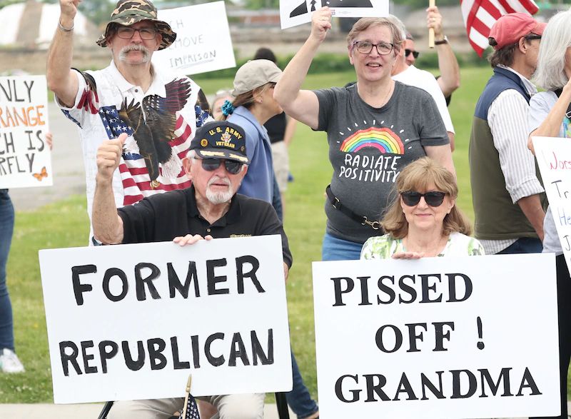 2 protest signs:
Former Republican 
Pissed Off Grandma 