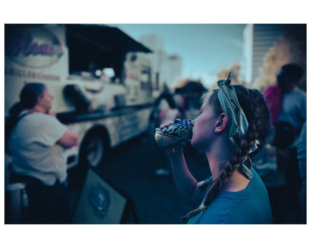 Girl drinking iced tea by a food truck