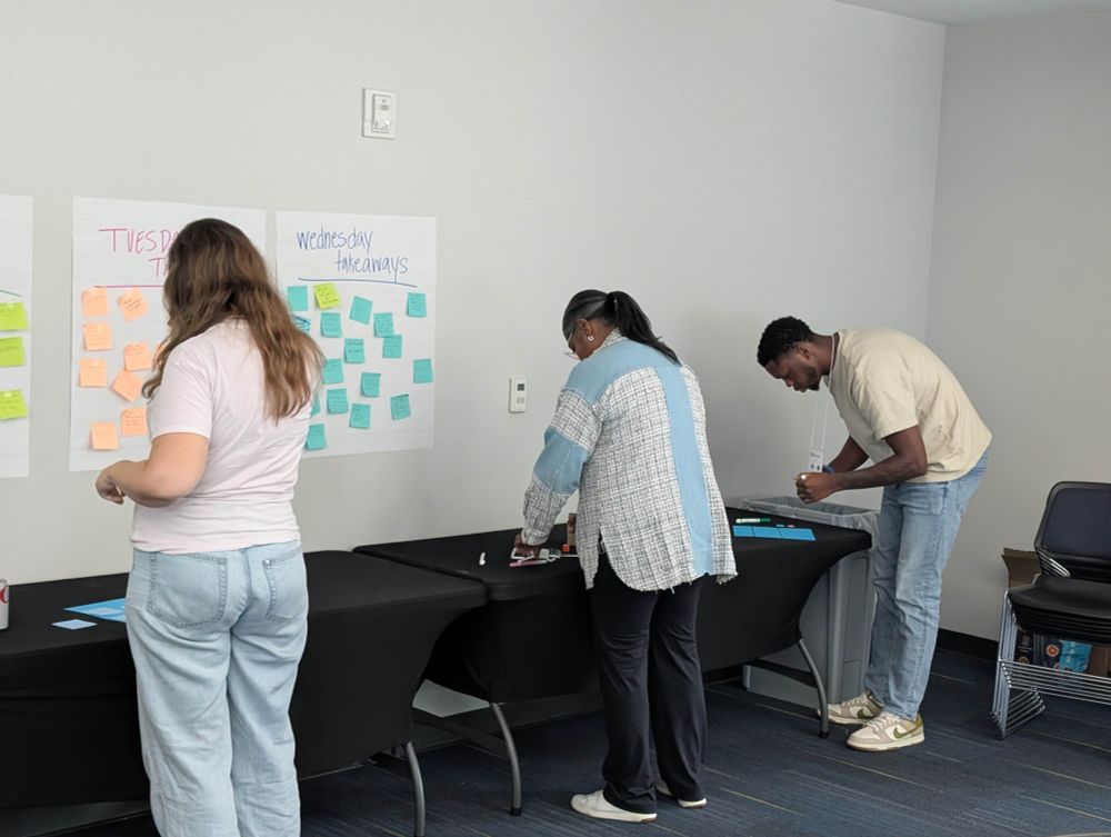 A photograph of ~3 educators using crafting tables.