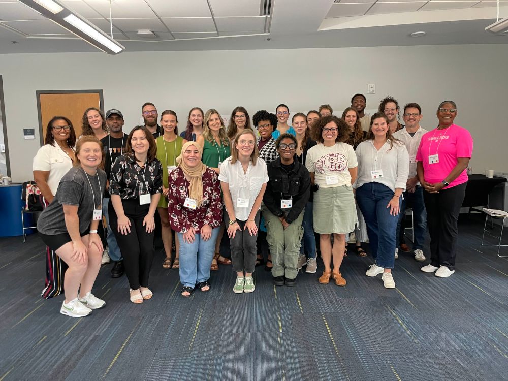 A photograph of ~25 standing educators in a group photo.