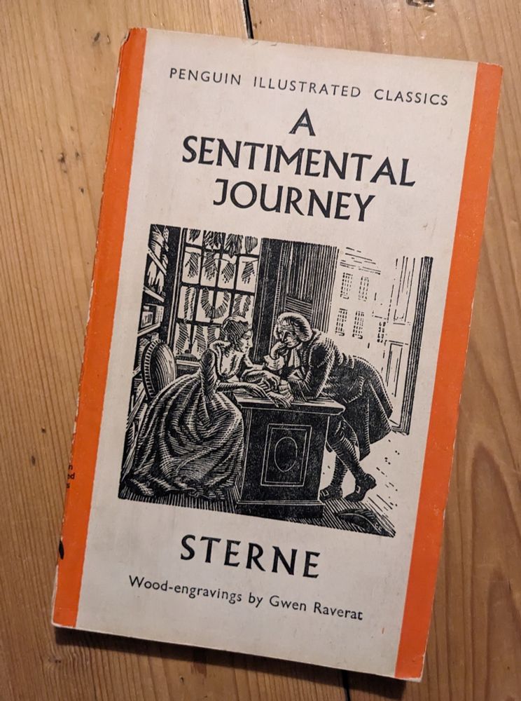 A photo of the 1938 Penguin Illustrated Classics edition of A Sentimental Journey by Laurence Sterne. The cover art is a wood engraving by Gwen Raverat.