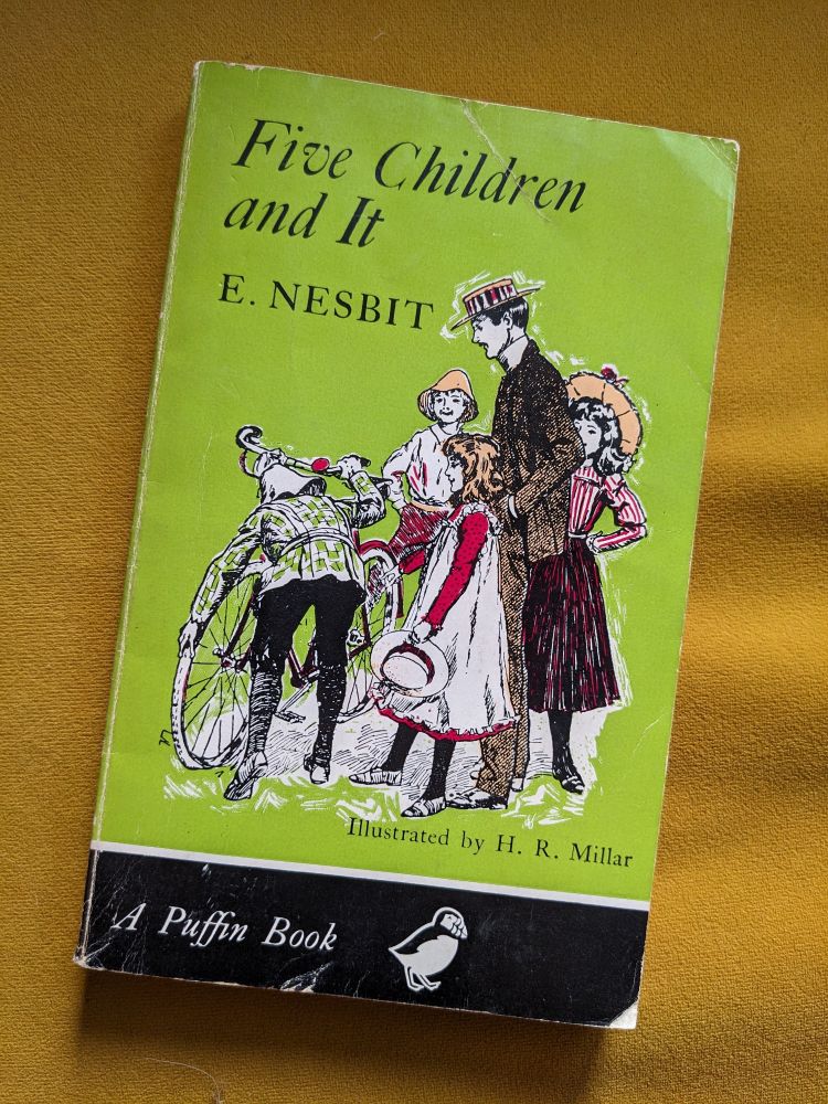 A photo of a copy of the 1969 Puffin edition of Five Children And It by E. Nesbit. The cover art is by H.R. Millar.