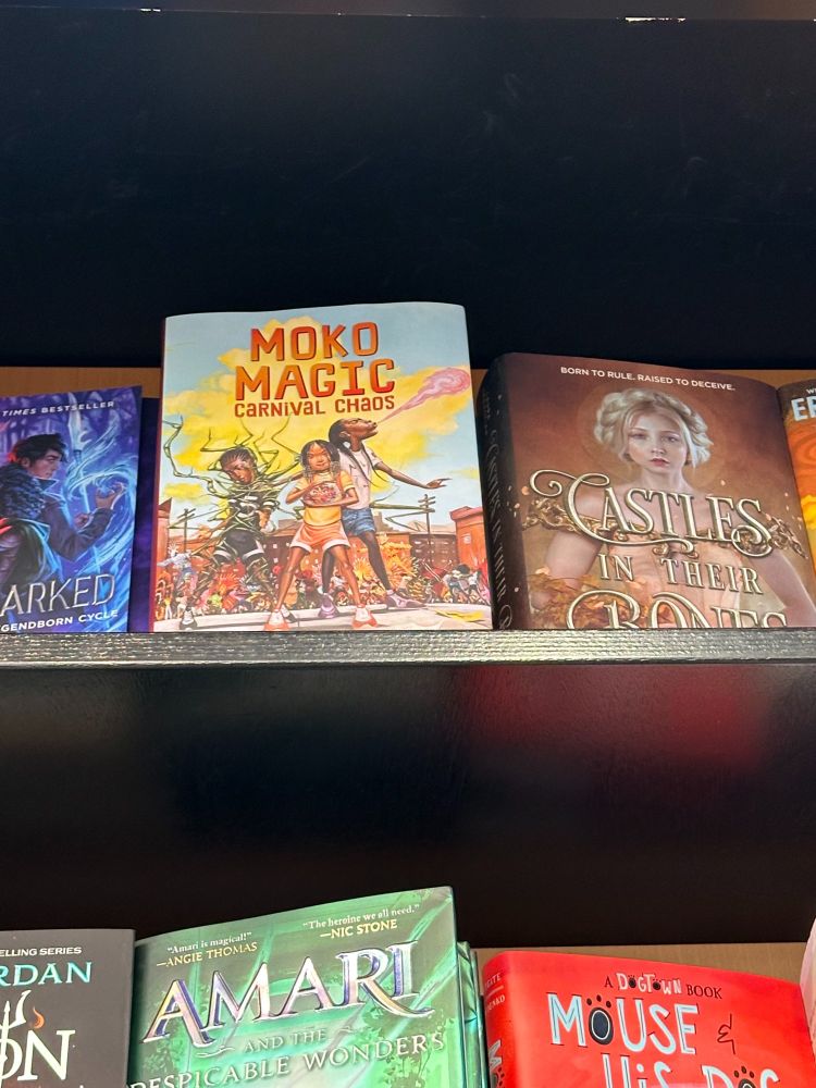 Book cover MOKO MAGIC shows three kids with magical powers against a blue and yellow sky & city.