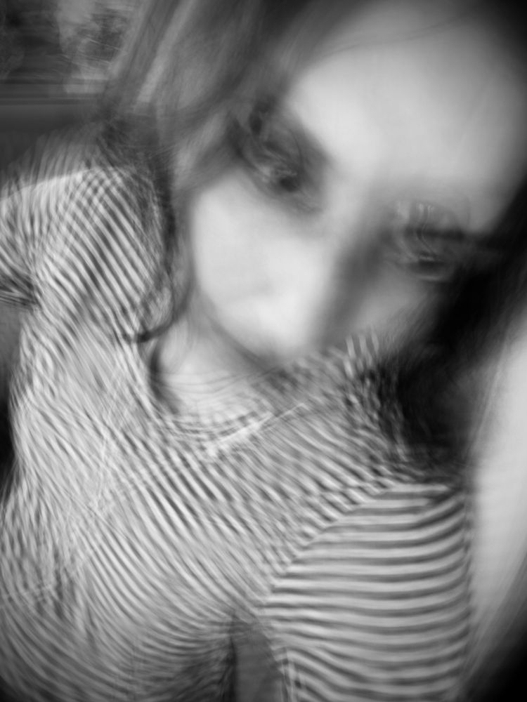 Blurry black and white portrait with streaks of motion. 