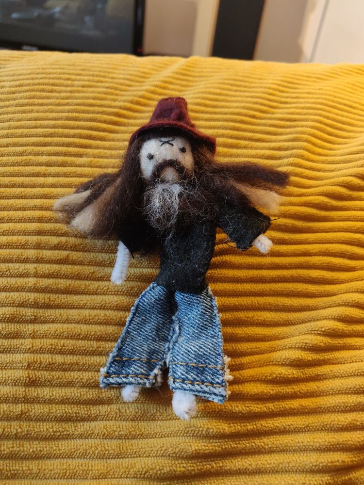 Very small Rob Zombie doll made with pipe cleaners, felt and wool.