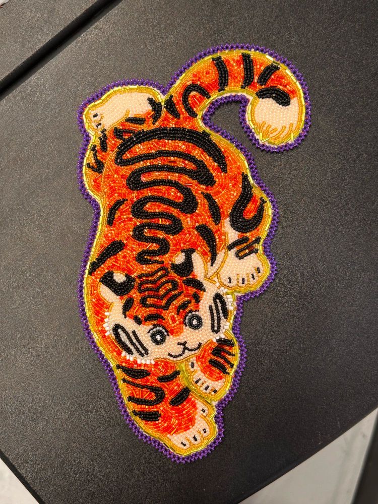 Large beaded tiger on a black background. 