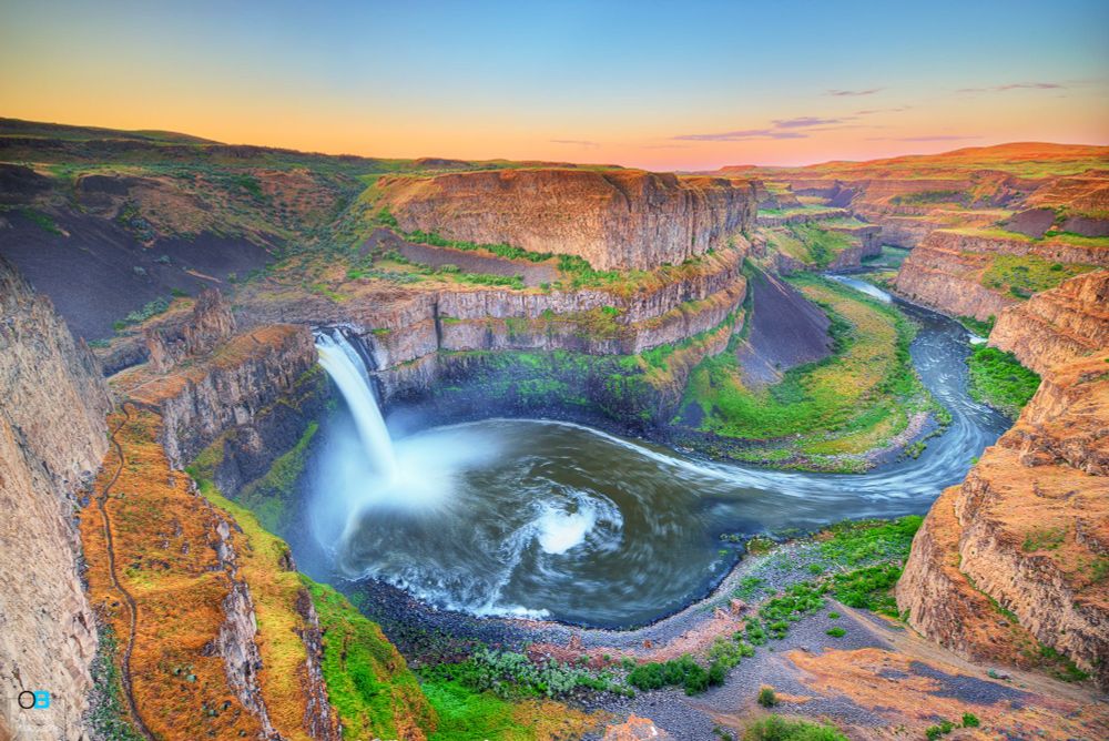 a beautiful sunrise panoramic overlooking palouse falls in washington state you can see down the river and the cliffs fade away in the distance