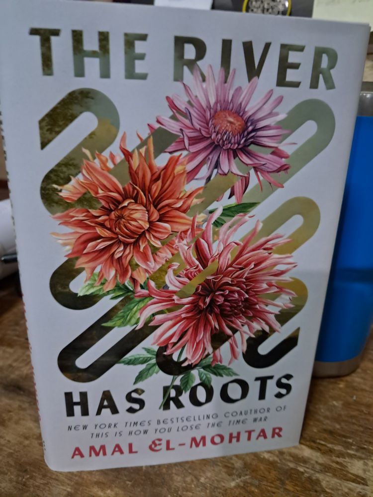 The cover of Amal El-Mohtar's novella THE RIVER HAS ROOTS featuring a family of dalias interwoven with a ribbon of willows, river, and yearning stems.