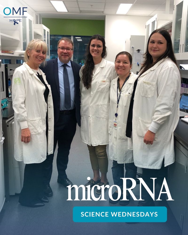 Dr. Alain Moreau and his research team at the OMF Collaborative Center in Montreal stand together in a lab. Dr. Moreau is in a suit, surrounded by four researchers in white lab coats. The setting is a bright, modern laboratory. The image features the OMF logo and the text “microRNA” and “SCIENCE WEDNESDAYS.” 