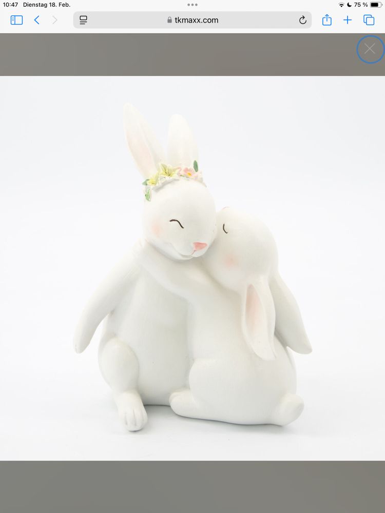 Little Statue of Two white bunnies hug each other , Both have their eyes closed 