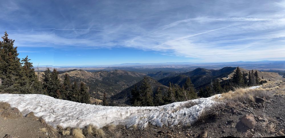 Mountain scenery with some snow and trees. 