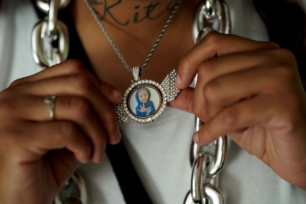 Shakenya Griffin displays a customized necklace with a photo of her son, Ramone “Red” Luckie Carter, during a celebration for Ramone’s life on what would have been his fourth birthday, at her home in Buffalo, July 6, 2024. (Libby March/Buffalo News)