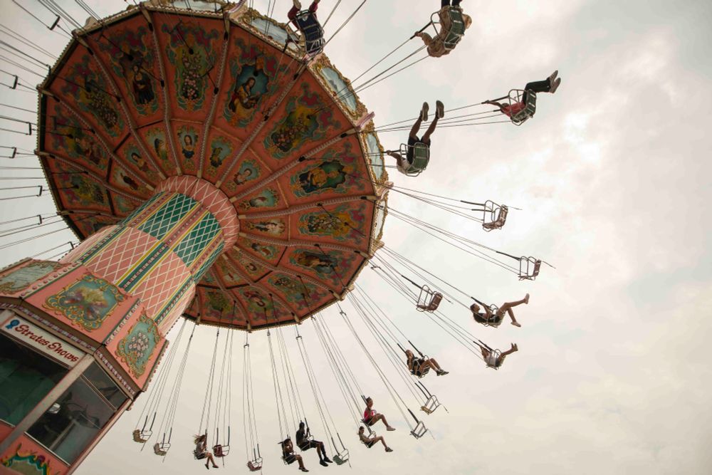 People fly through the sky on the “Wave Swinger” ride on the first day of the Erie County Fair at the Hamburg Fairgrounds in Hamburg, August 6, 2025. (Libby March/Buffalo News)