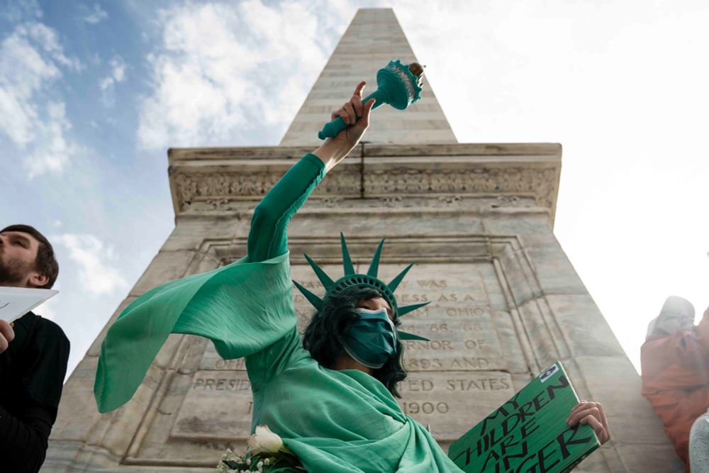 A demonstrator dressed as the Statue of Liberty holds a sign reading “My children are in danger” during the Buffalo United March in downtown Buffalo, April 5, 2025. The march was organized in support of immigrant rights, labor, Social Security, racial and climate justice, Medicaid, education, LGBTQIA+ rights, and more. (Libby March/Buffalo News)