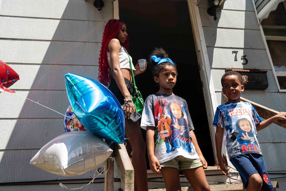 Wearing T-shirts memorializing Ramone “Red” Luckie Carter, children stand on the steps of Shakenya Griffin’s home, the site where her son Ramone and his older sister Ja'miya were struck by gunfire, during a celebration for the life of Ramone on what would have been his fourth birthday, at his mother’s home in Buffalo, July 6, 2024. Ja'miya survived her injuries, but Ramone was pronounced dead at Erie County Medical Center the night the two children were shot. (Libby March/Buffalo News)