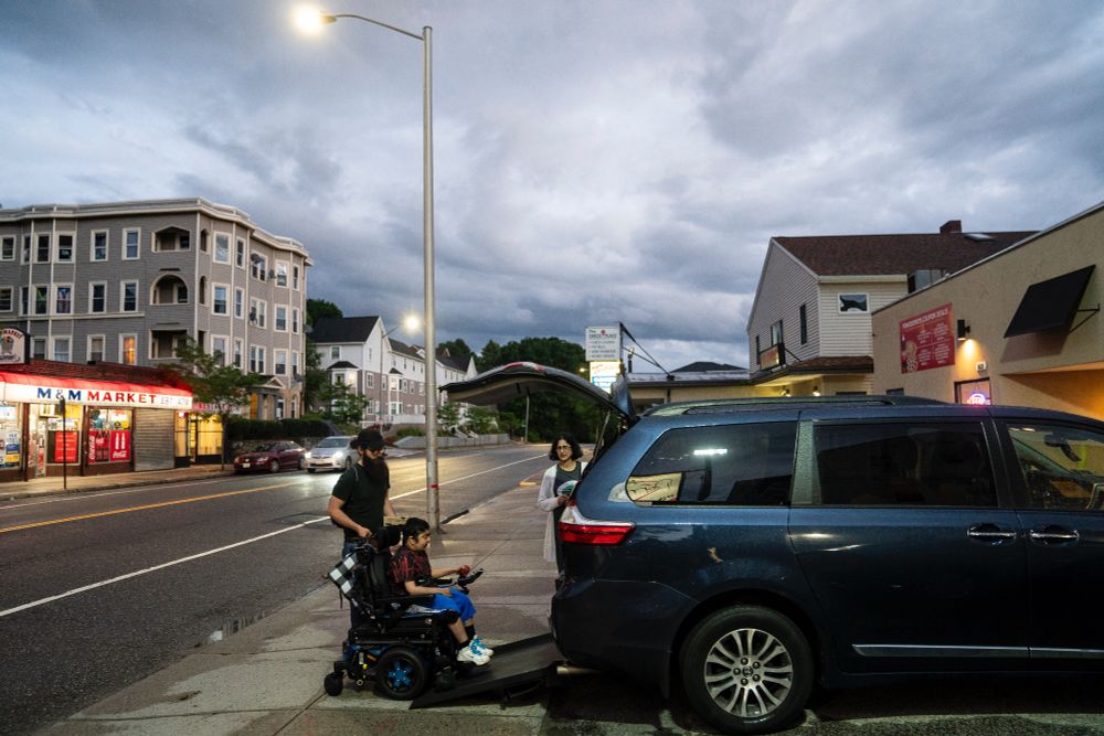 Suneel Ram motors up the van ramp, leaving a pizza shop after stopping for dinner with his mother Neera Gulati, and aide, David Rowe, before heading to their hotel in Worcester, Mass., June 11, 2024. They have driven over 400 miles from Williamsville, N.Y. to bring Suneel for an annual visit to the Duchenne Muscular Dystrophy Center at UMass Memorial Medical Center in Worcester. Driving time, with stops, was almost eight hours. (Libby March/Buffalo News)