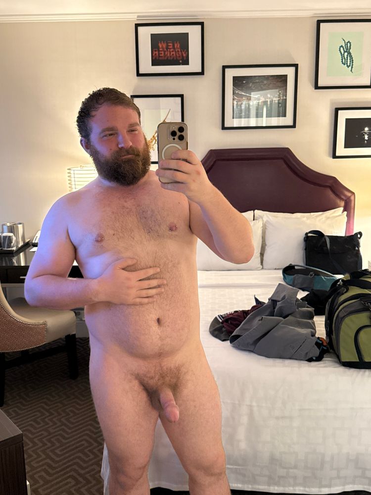 Me standing naked with a chub in front of a full length mirror in my hotel room. 