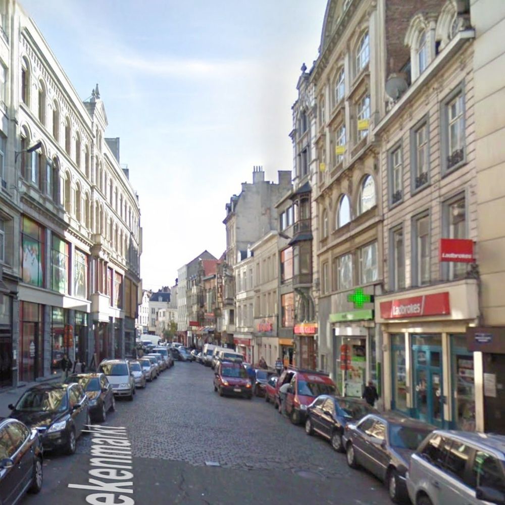 Picture of a fairly standard European street. One way. Cars parked on both sides and room for two cars abreast in the travel lane. Photo from Google street view. It's a sunny day but the street is shaded.