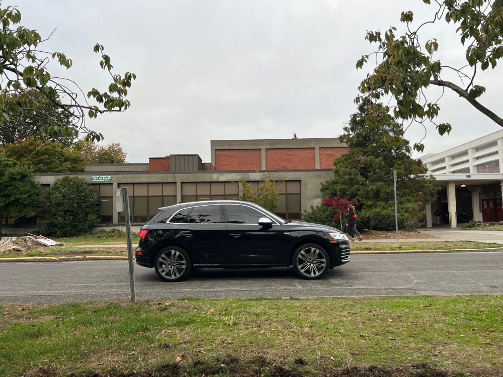 Fancy black car rolling down 1st Avenue West, flouting the closure.