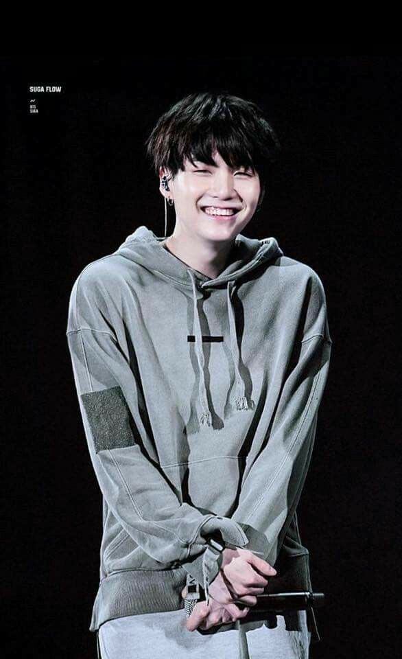 Picture of Yoongi looking very cutie patootie with a comfy gray sweatshirt on. He’s giving a big, heart melting smile