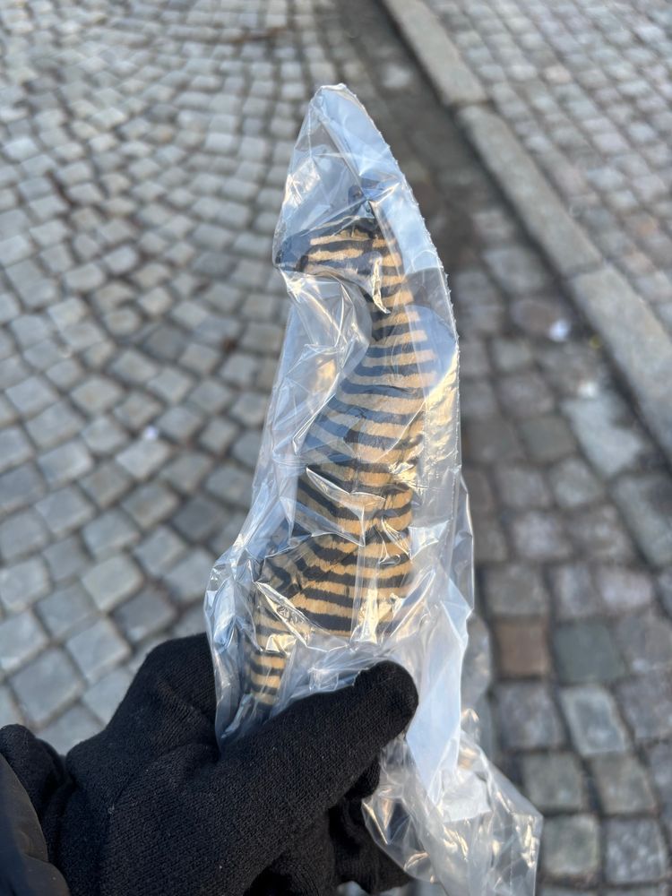 A wooden zebra sculpture in sitting style 