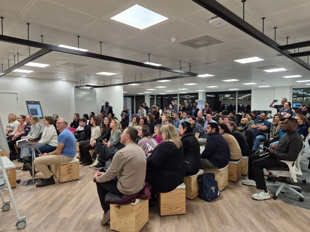 Meeting space full of people watching a presentation