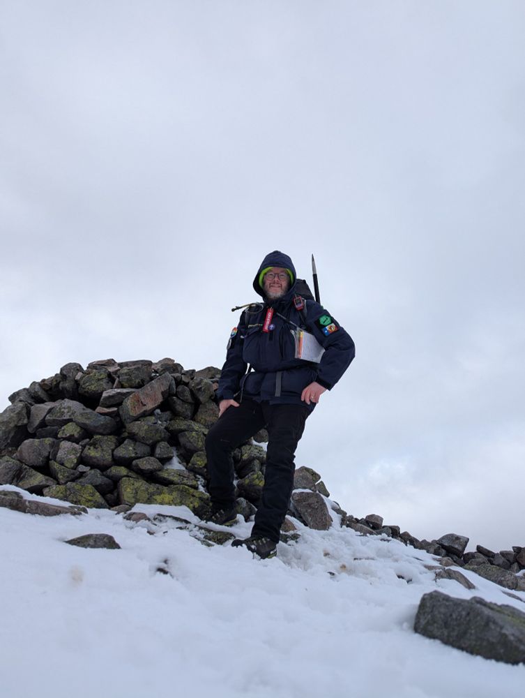 Me standing in the snow next to the cairn on top of Càrn Liath (on the Bheinn a' ghlo). 

It's cloudy and windy up here, and about 0°C but doesn't feel too cold out of the wind. 

Càrn Liath is my 10th Munro. 
